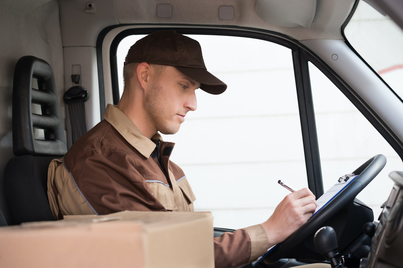 Delivery Driver Doing Paperwork in Truck