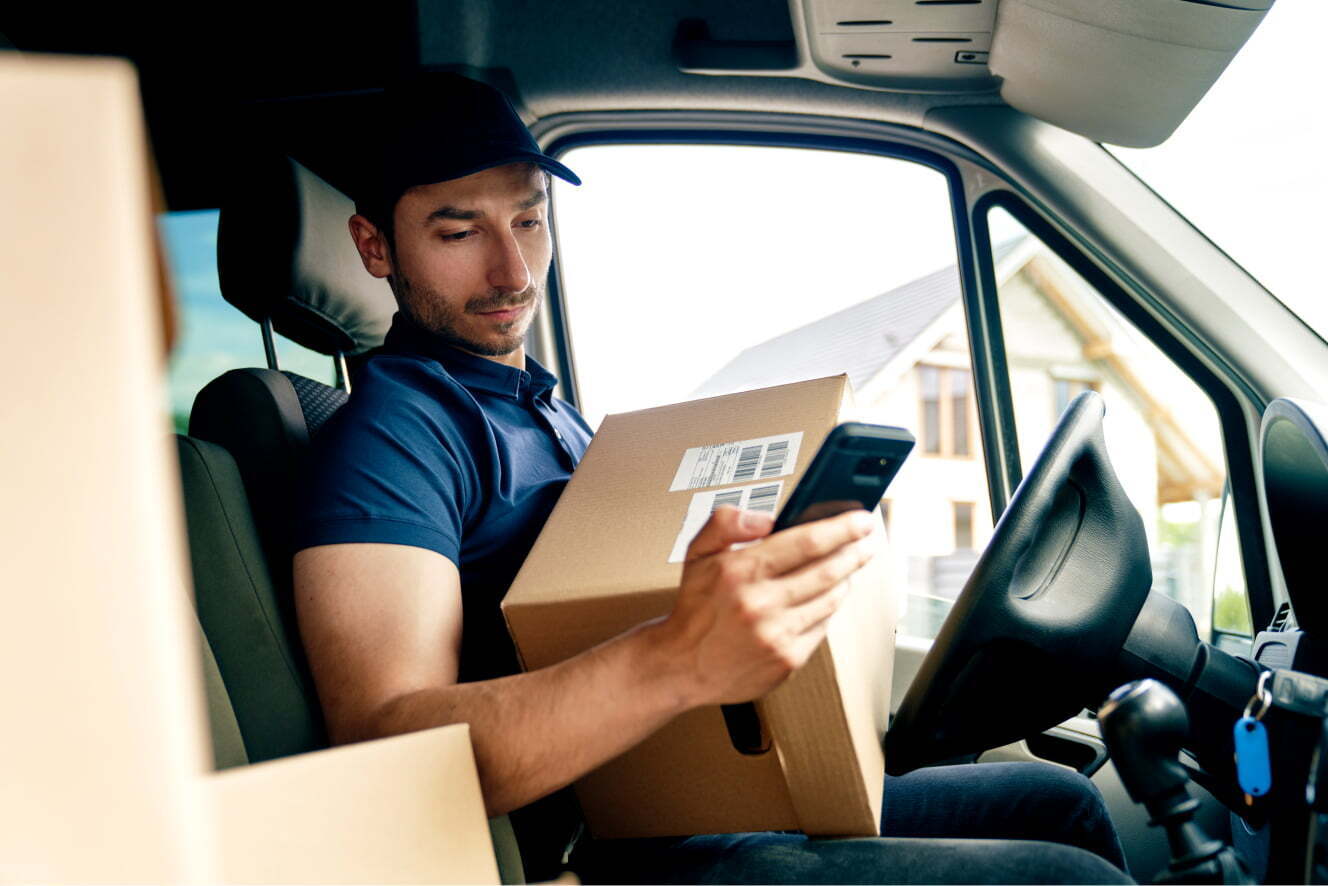 Delivery Person Sitting in Truck With Package