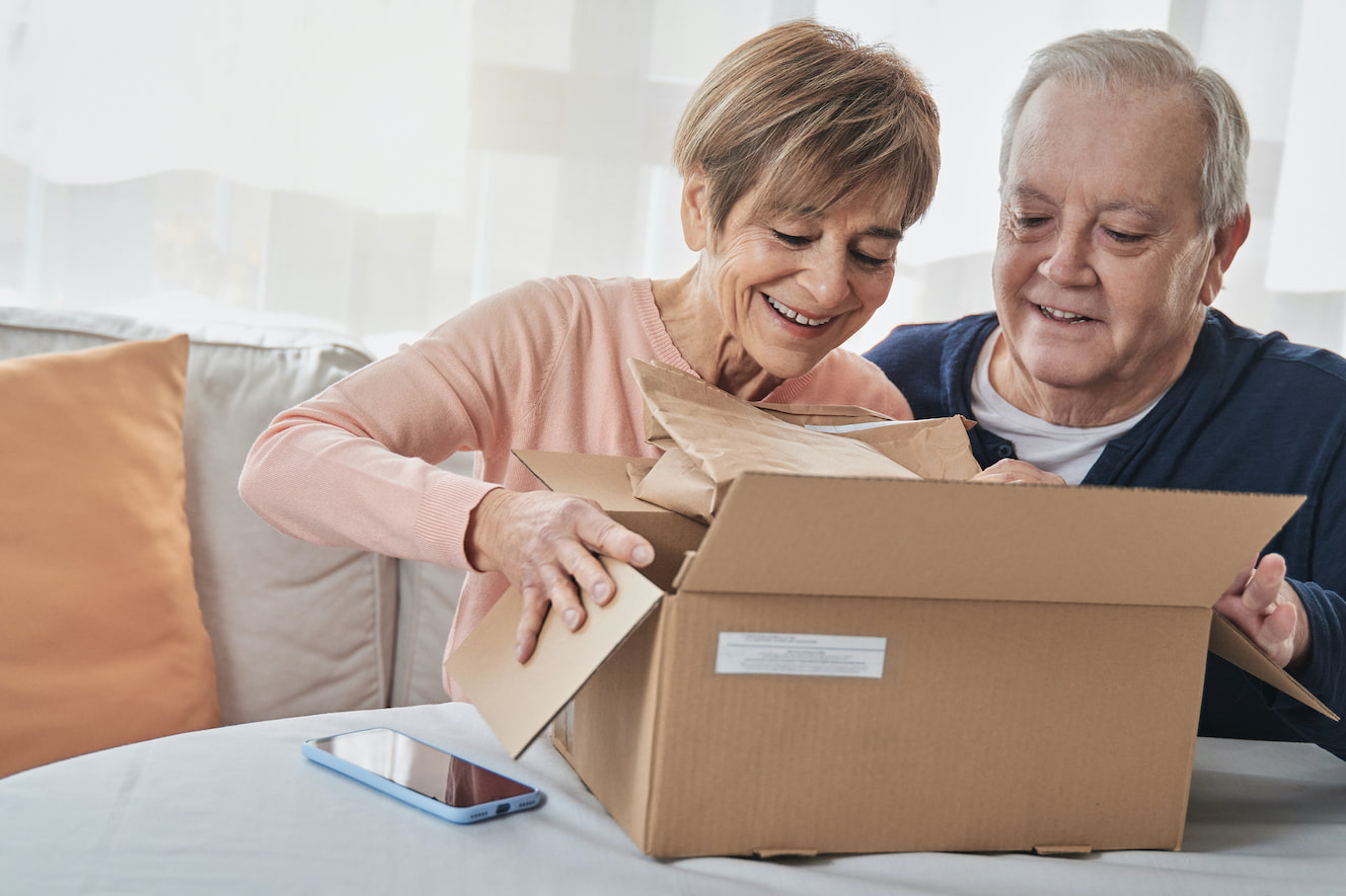 Elderly couple opening package
