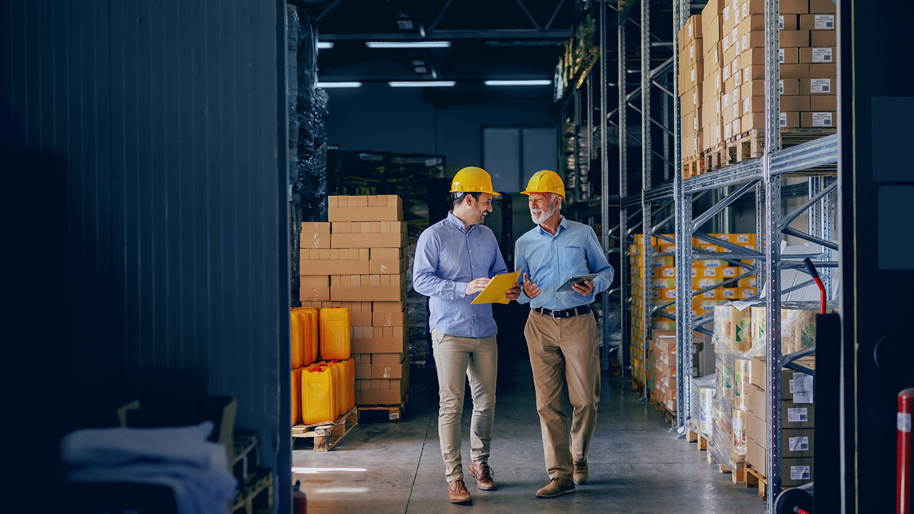 Two People In Hardhats Conversing